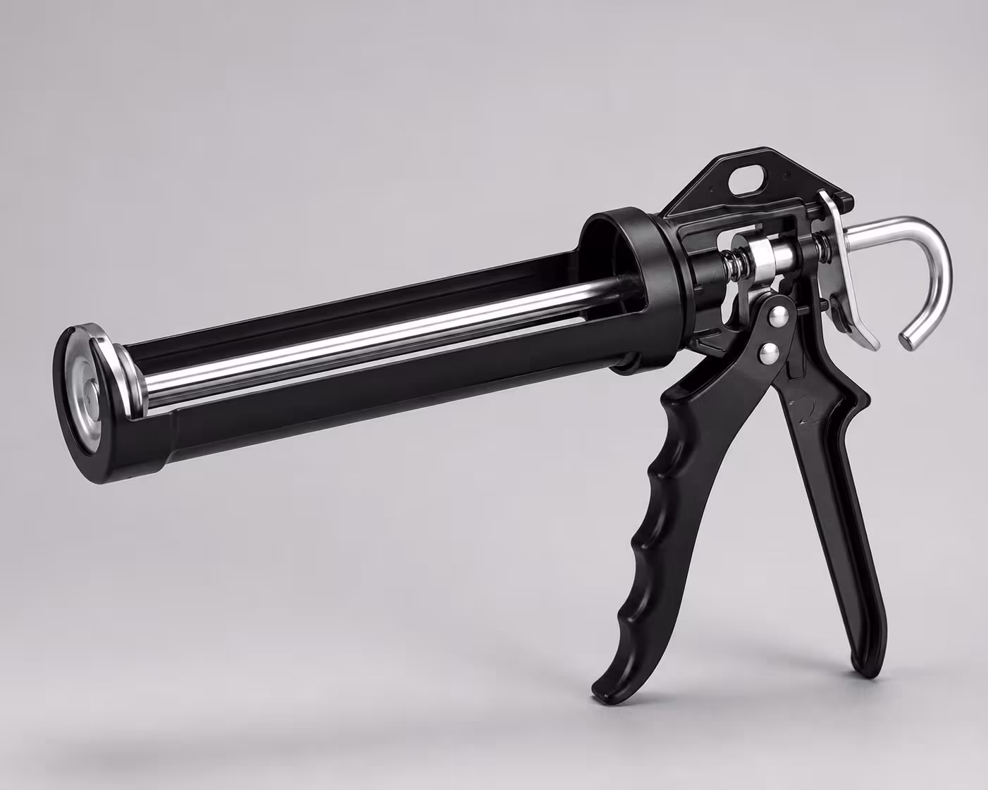 Manual caulking gun with pressure-release mechanism for dripless operation