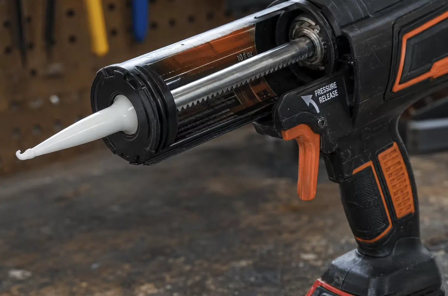 Anti-drip pressure release valve on a cordless caulking gun barrel that stops sealant flow when the trigger is released