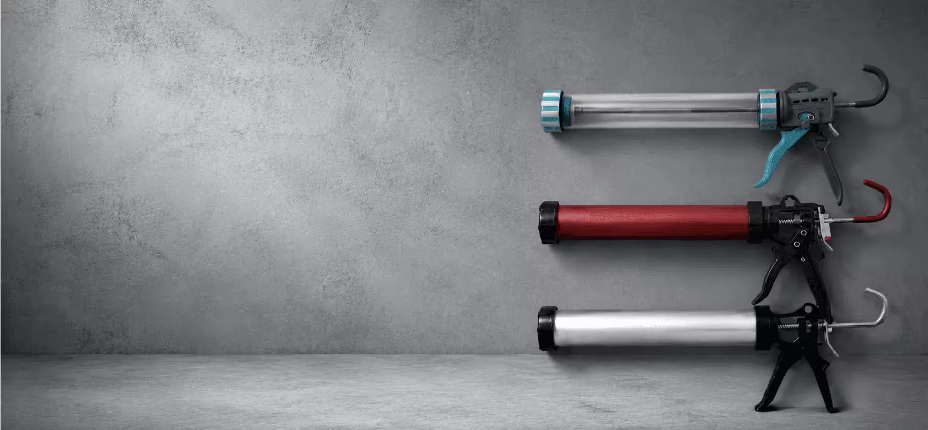Manual sausage caulking guns for professional sealant dispensing on a clean industrial gray background